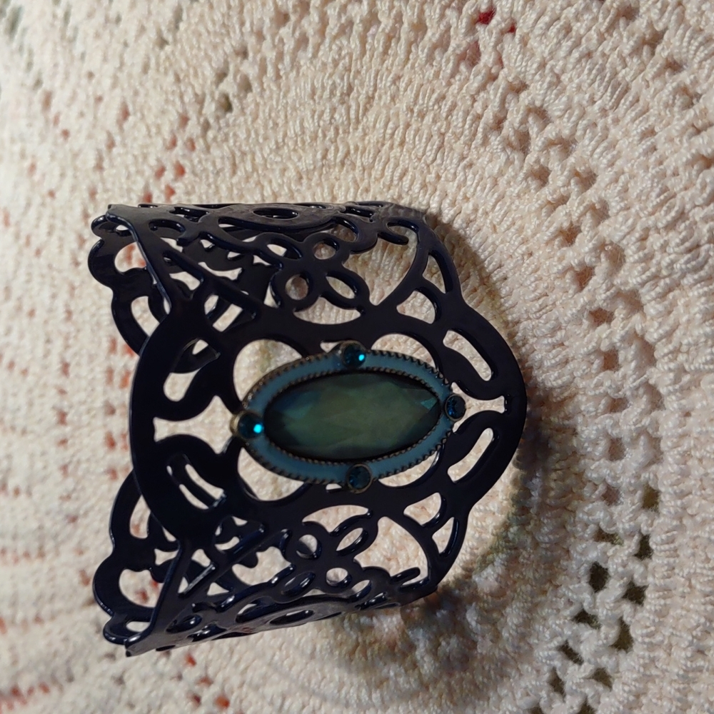 Dark blue woman's with green stone. Never worn... No tags.